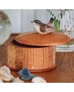 Houten opbergdoos Winterkoning van Wildlife Garden met licht geopend rond deksel en houten winterkoninkje, op een tafel met schelpen en glazen vaas.